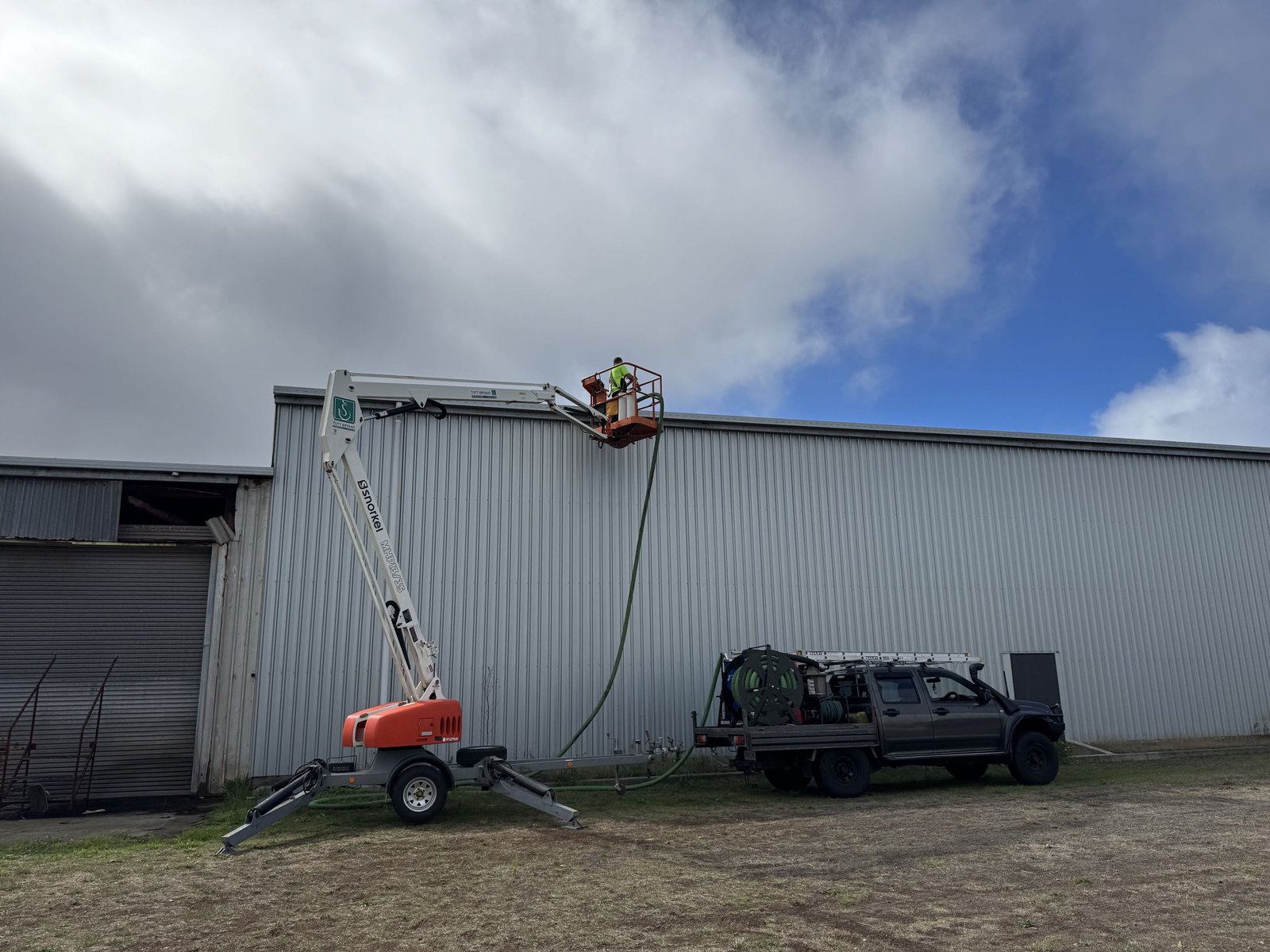 Boom lift and gutter vacuum rig at a commercial property